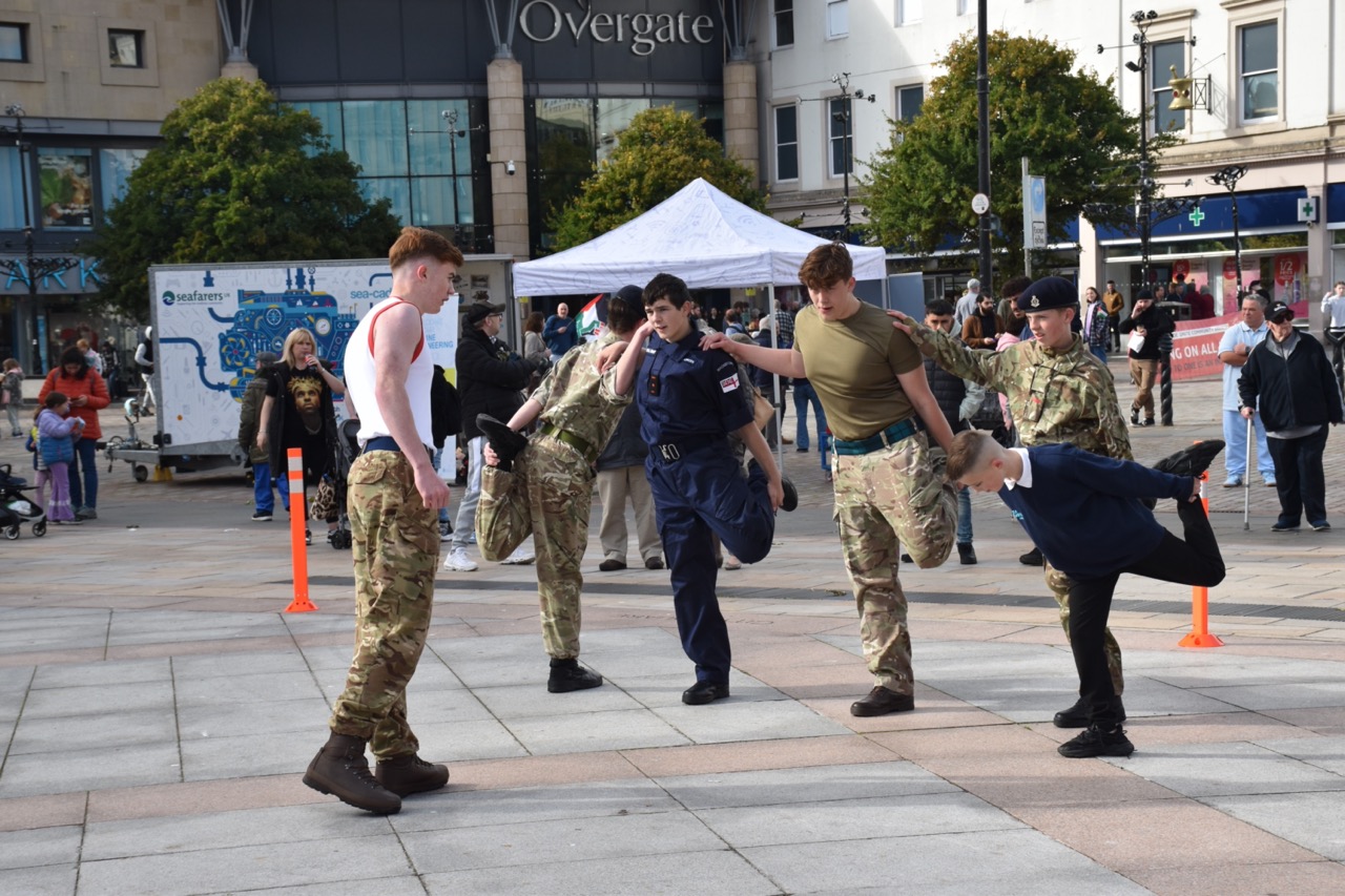 Cadets and Physical Training Instructor stretching.