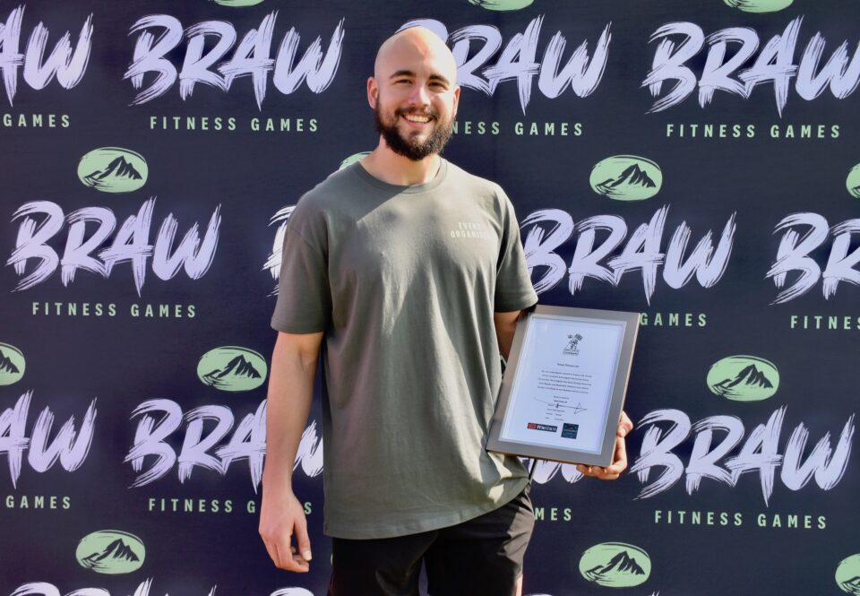 Braw Fitness Games organiser Rhys Spackman holds the Armed Forces Covenant certificate.