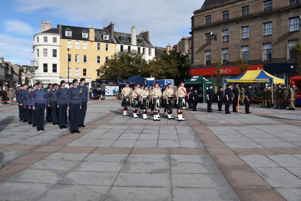 Cadets standing within their Services.