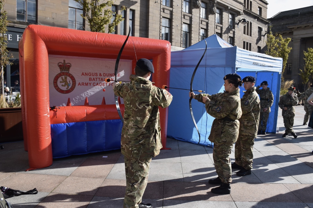 Three cadets at the tag archery stand.