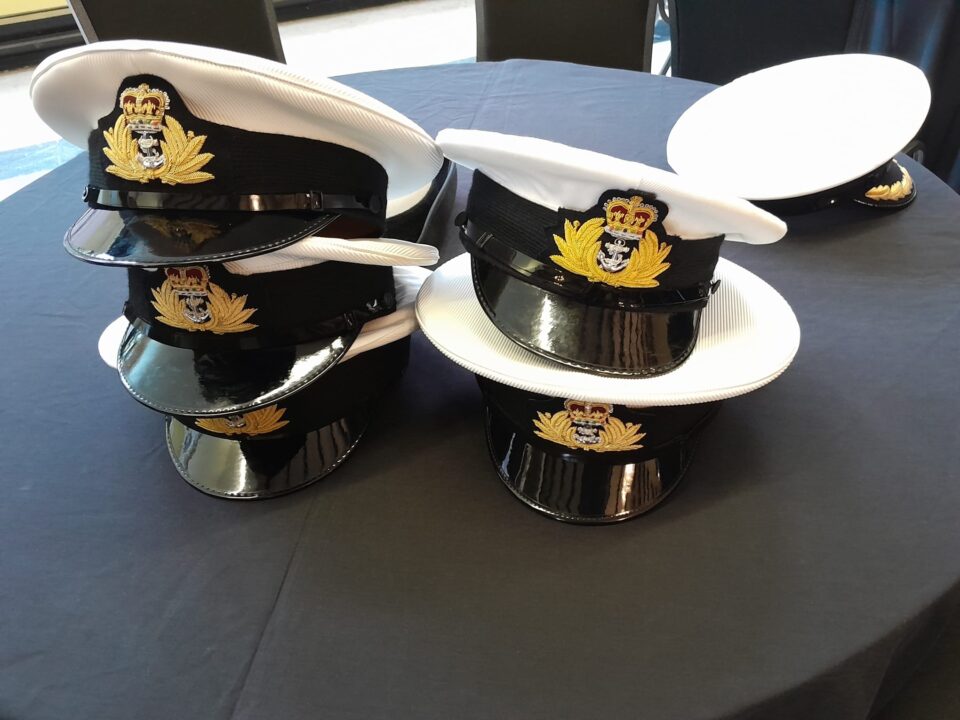 A pile of Royal Navy hats.