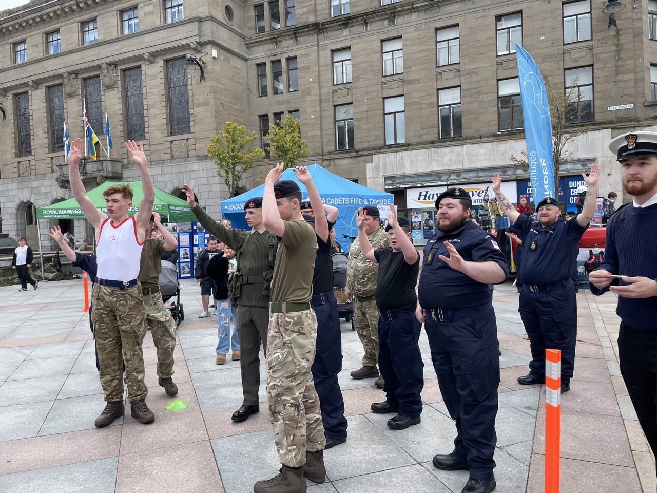 The Royal Marines team with their hands up.