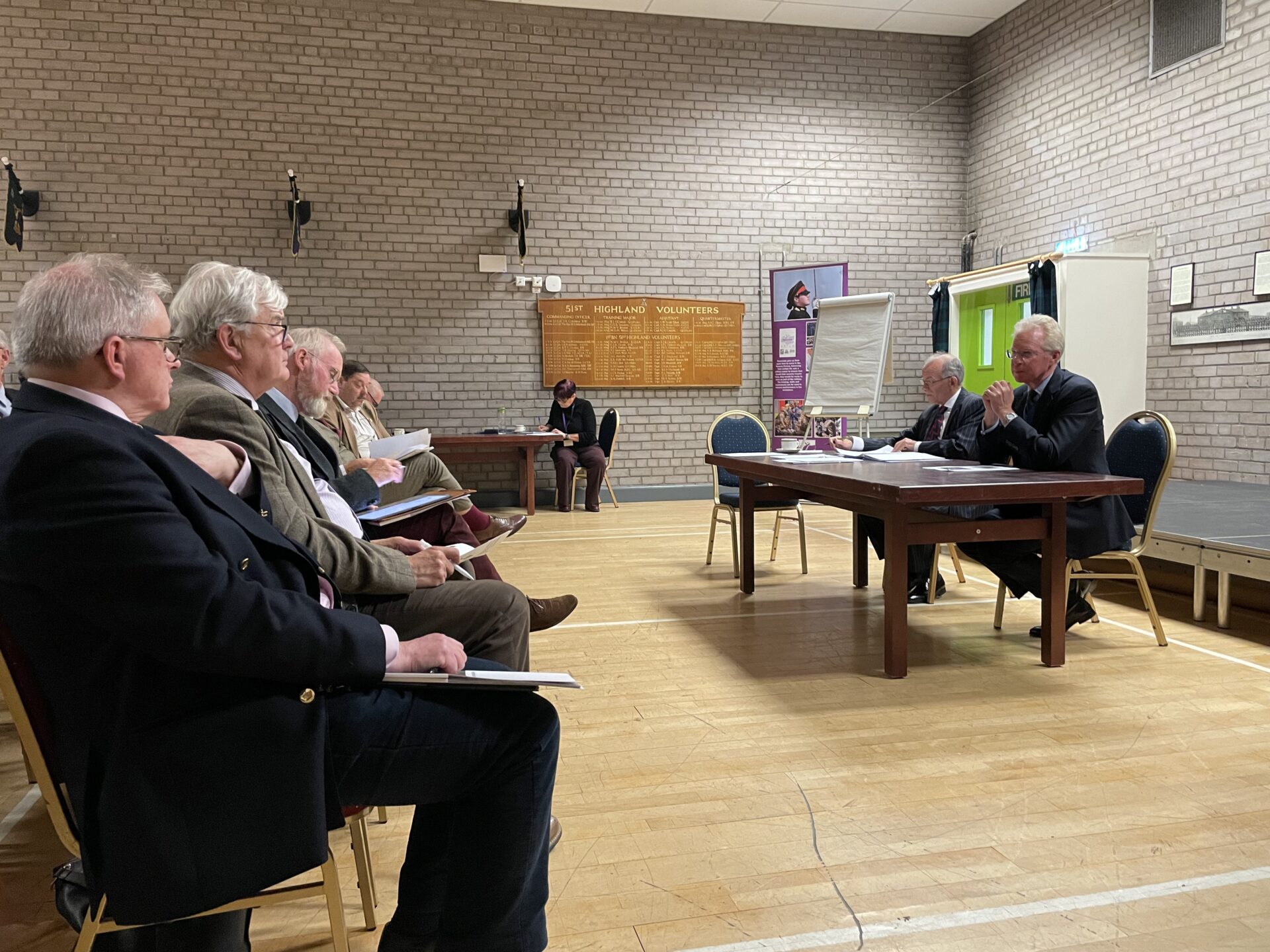 The Southern Area Chair and HRFCA Chief Executive sitting in front of the members.