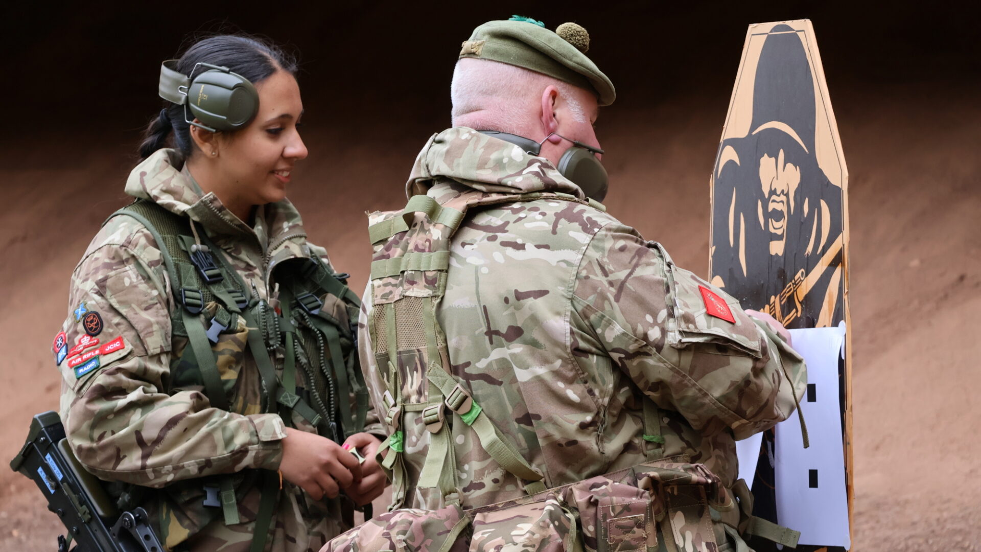 A cadet smiles as targets are checked.