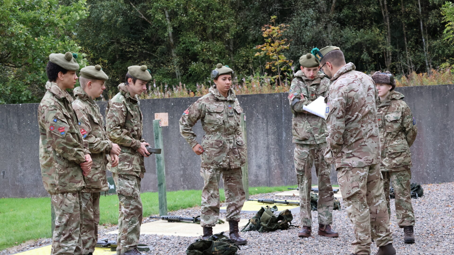Six cadets being briefed by an Adult Volunteer at the range.