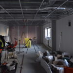 A contractor continuing with work in one of the office spaces.