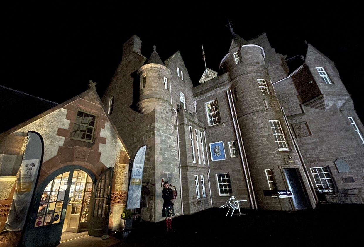 The Black Watch Castle and Museum with piper Private Kieran Murray standing outside.