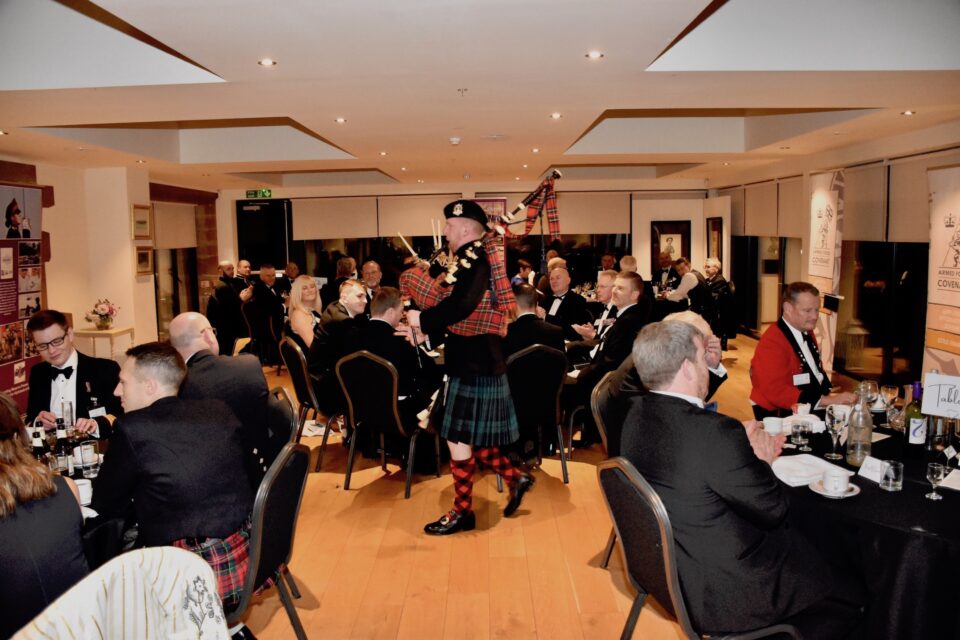 Piper Private Kieran Murray performs a set to the seated dinner guests.