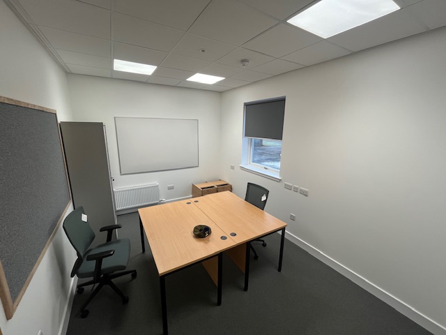 Bright and airy office space in the new extension with a pair of desks and chairs.