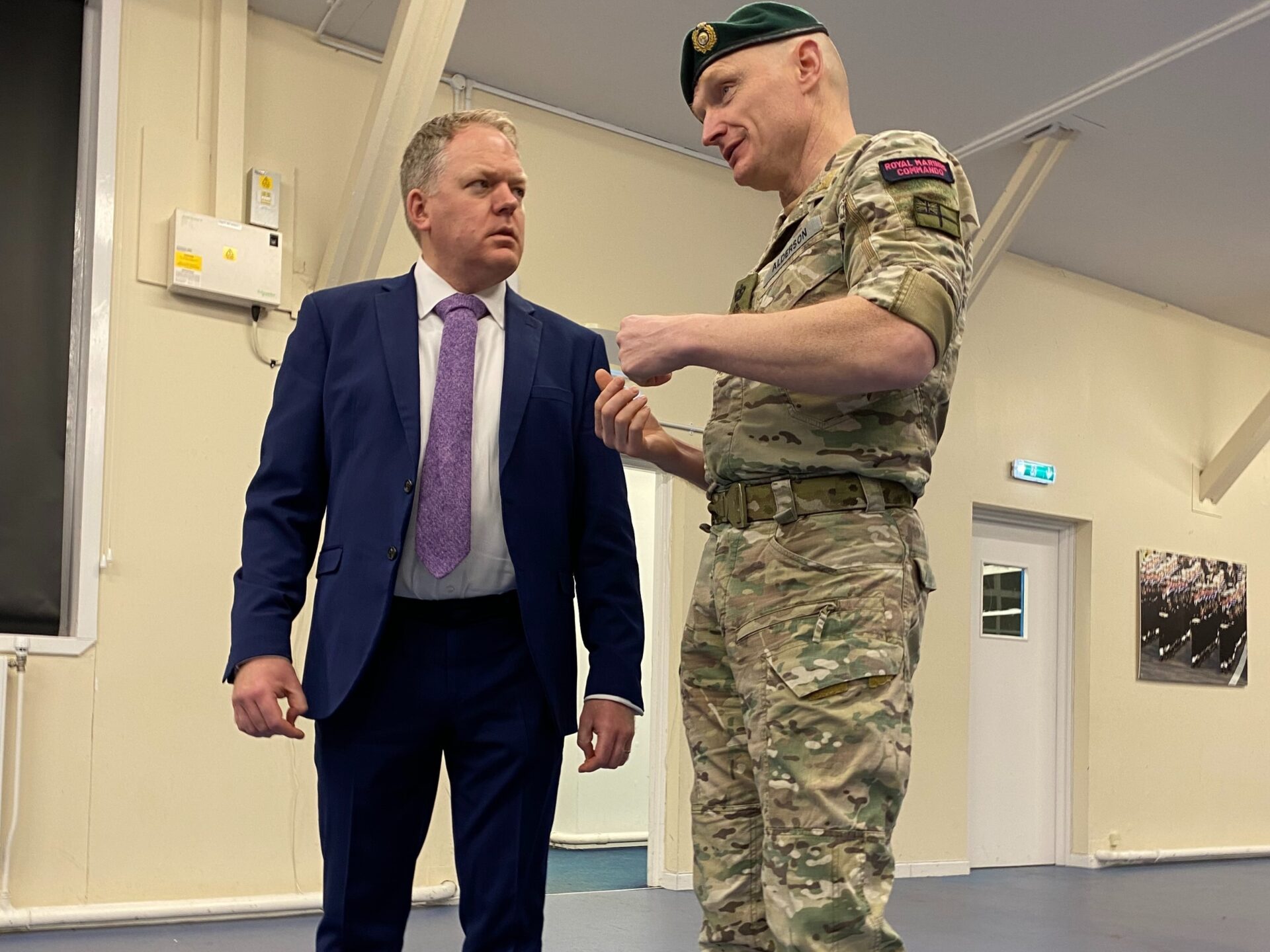 A member of the Royal Marines Commando speaking to a person.