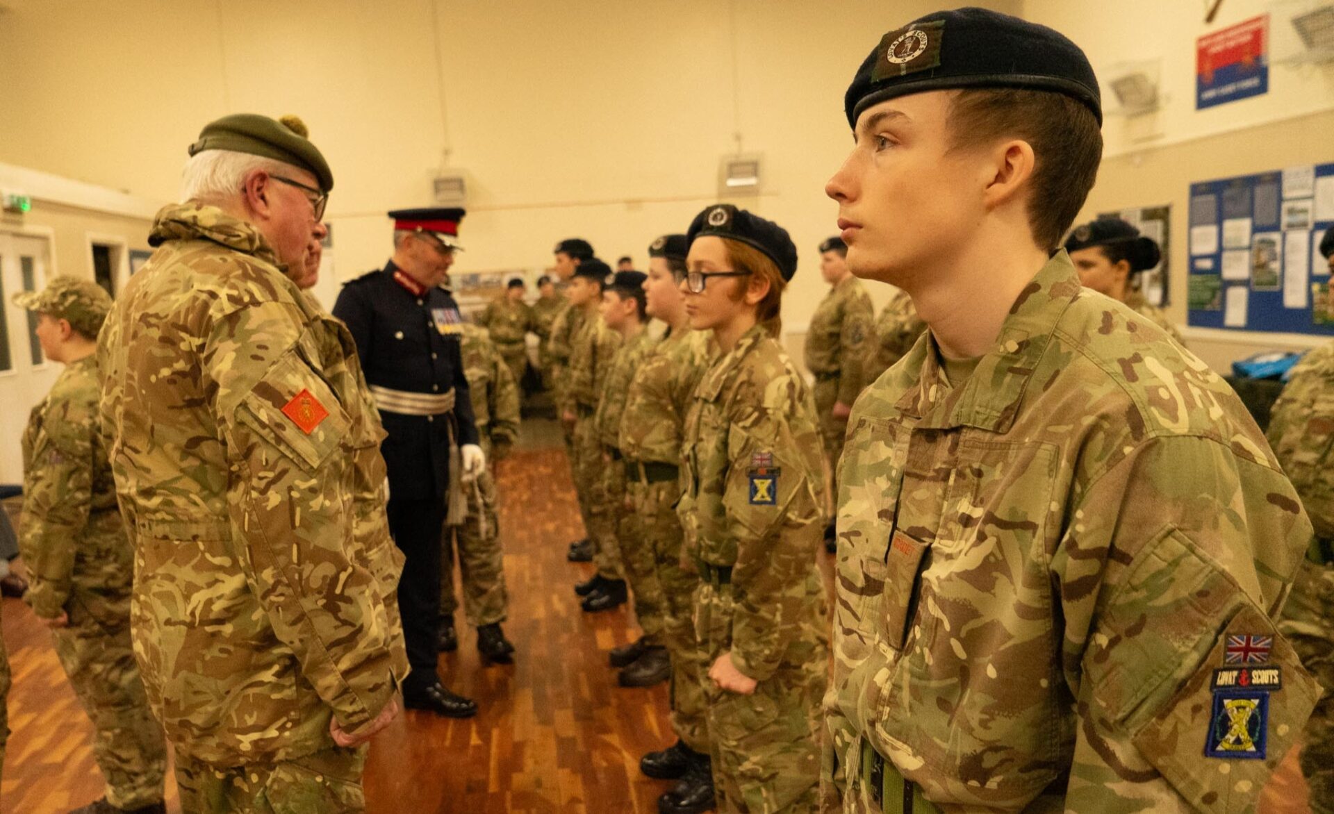 The Lord-Lieutenant of Shetland and Adult Volunteers in-between rows of Army Cadets.