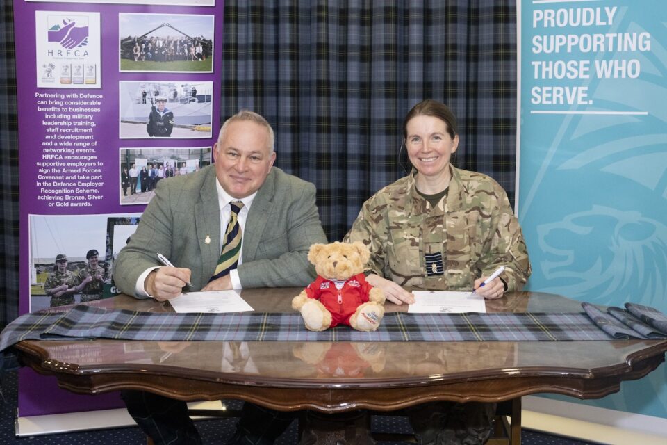 Lieutenant Colonel (Retd) Toby Christie, CEO of The Gordon Lennox Estate Company Limited, and Group Captain Sarah Brewin sign the Armed Forces Covenant at RAF Lossiemouth.