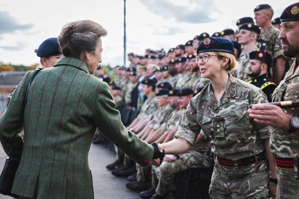 The Princess Royal shakes hands with Lieutenant Colonel Chloe O'Brien, Commanding Officer of 154 (Scottish) Regiment RLC as other members of the Regiment look on.